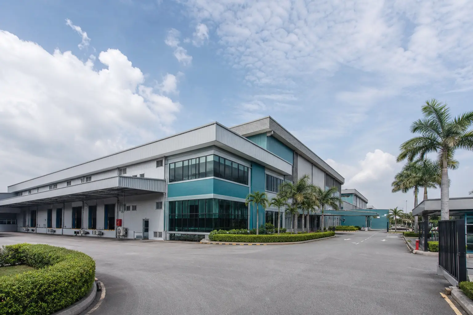 Industrial manufacturing campus buildings under a tropical sky